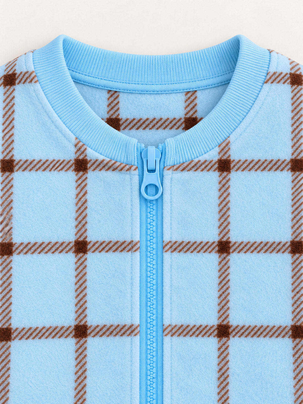 Blue ribbed round neckline and top ring-pull zipper detail on the ice blue plaid onesie