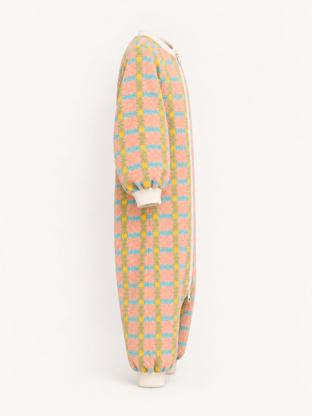 Side view of the pastel plaid onesie with long sleeves and cream ribbed cuffs