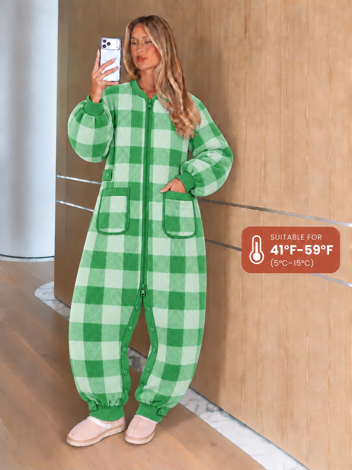 Adult model wearing the green gingham onesie with front pockets and ribbed cuffs