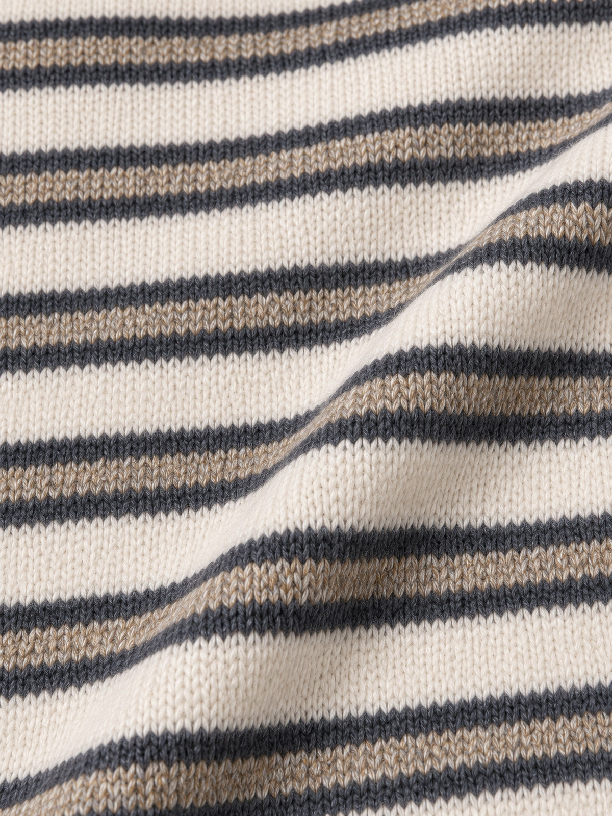 Close-up of the cream, charcoal and taupe striped fabric's knit texture