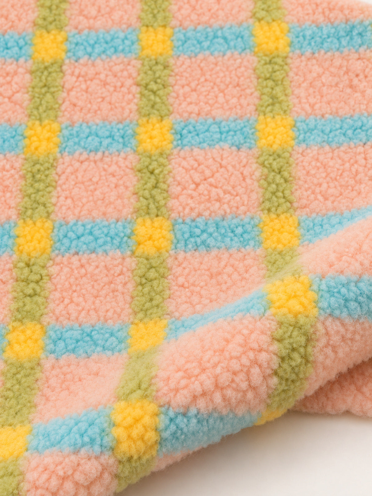 Close-up of the textured pastel pink, aqua, green and yellow plaid fabric