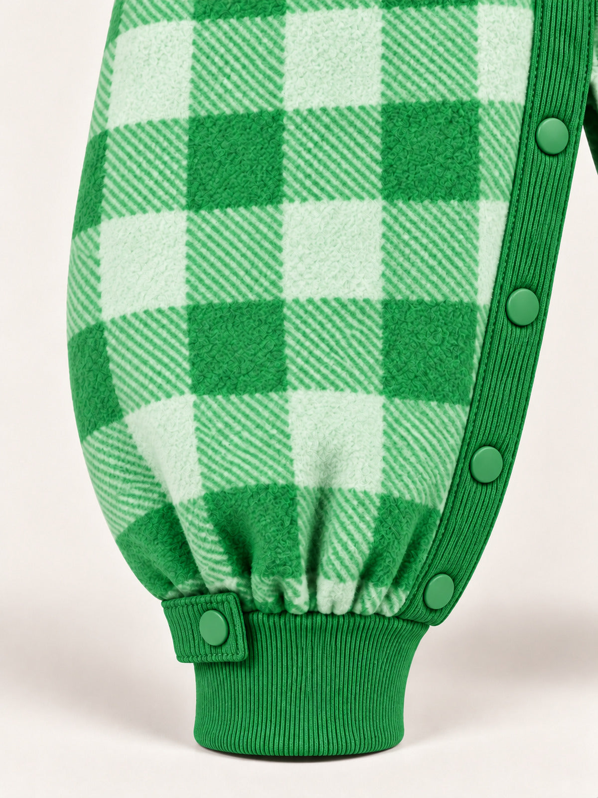 Close-up of the green inner-leg snaps, ankle snap tab and ribbed ankle cuff