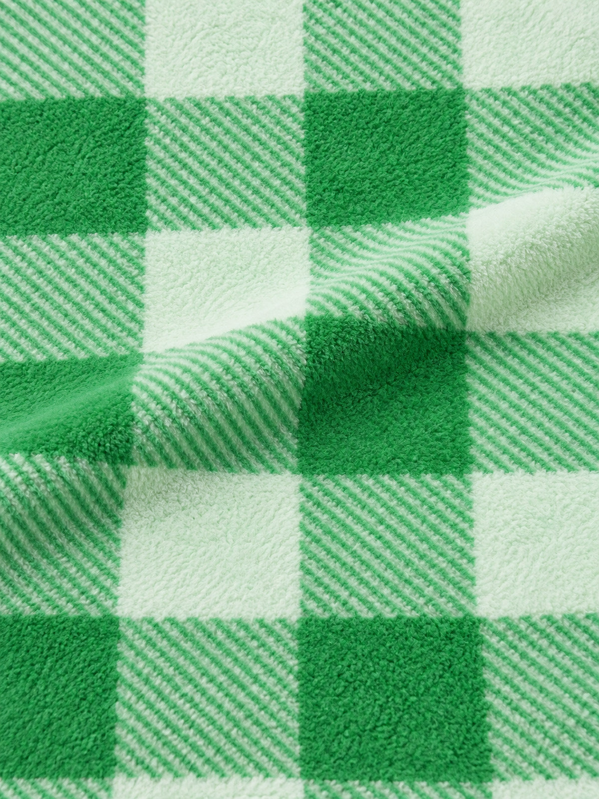 Close-up of the green and light mint check pattern on the adult onesie