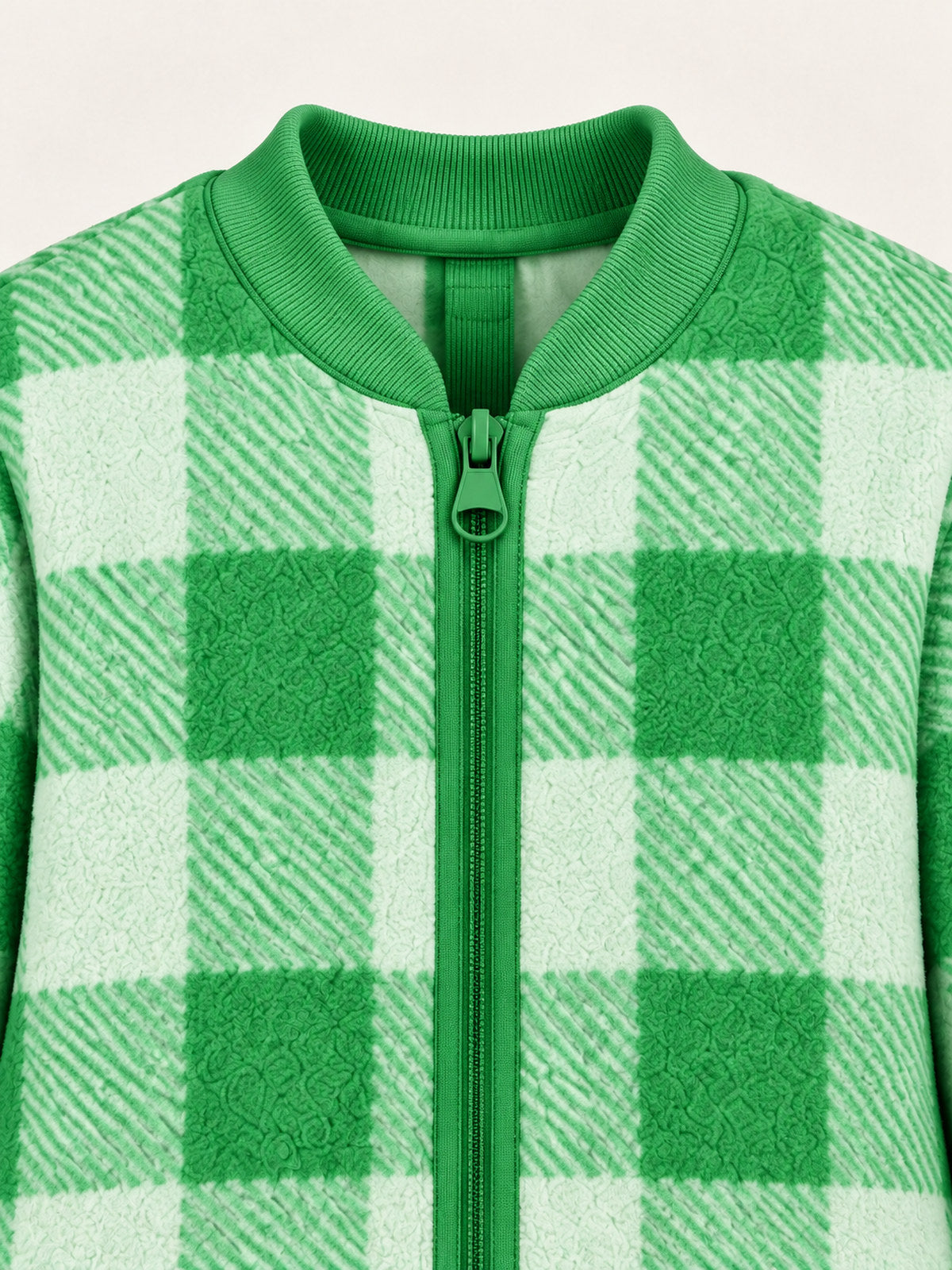 Close-up of the green ribbed round neckline and front zip
