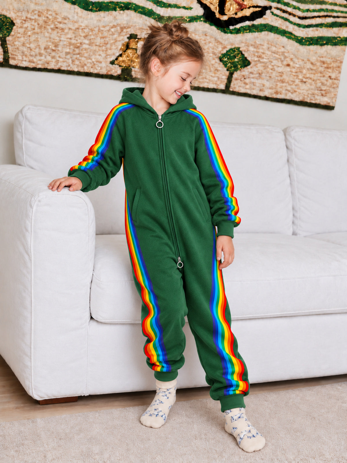 Child wearing the green rainbow stripe hooded onesie